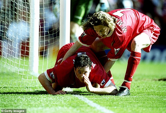 Robbie Fowler celebrates a goal against Everton with Steve McManaman