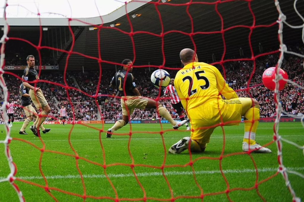 Darren Bent scores via a beachball against Liverpool goalkeeper Pepe Reina