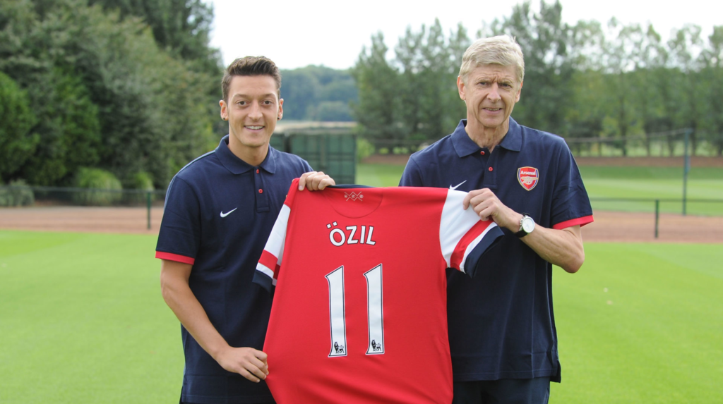 Mesut Ozil with Arsene Wenger at his Arsenal unveiling after a deadline day transfer